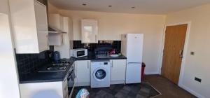 a kitchen with a white refrigerator and a washer at SELF CHECK-IN PENTHOUSE APARTMENT in HALIFAX CENTRE in Halifax +10 photos