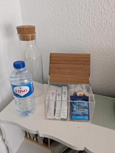 a bottle of water and other items on a shelf at Beach Avenue Suite in Apúlia