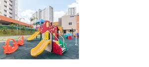 a playground with a slide in a city at Apartamento em Olímpia in Olímpia