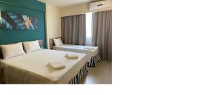 a hotel room with a bed and a chair at Apartamento em Olímpia in Olímpia