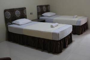 Voodi või voodid majutusasutuse Anoi Itam Resort toas