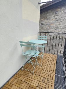 a table and two chairs sitting on a balcony at Piccolo gioiello rustico in Losone