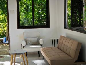 a living room with a couch and a chair at Seanna's Inn in San Juan