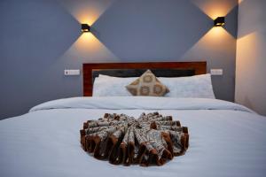 a bedroom with a bed with a brown blanket on it at Njiro Luxury in Arusha +35 photos