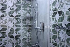 a bathroom with a shower with a glass door at Beshic Hostel in Tashkent +20 photos