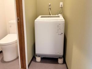 a washing machine in a bathroom next to a toilet at あかねや in Marugame +43 photos