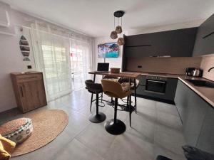 a kitchen with a table and chairs in a room at Boho Studio Enjoy in Neoi Epivates