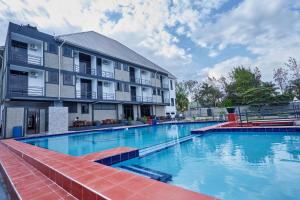 a large swimming pool in front of a building at Njiro Luxury in Arusha
