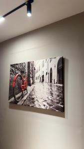 a picture of a bike hanging on a wall at Agora ApartHotel in Tirana +45 photos
