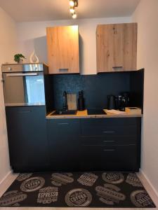 a kitchen with black cabinets and a counter top at Ferienwohnung Evelina in Bad Neuenahr-Ahrweiler