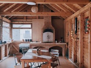 a large kitchen with a table and a fireplace at Casa Krista in Bran