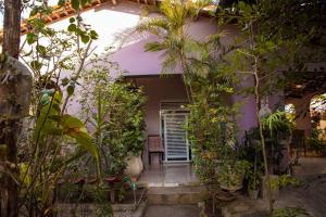 a house with a bunch of plants around it at Casa com Varanda, Quintal e Churrasqueira em Bonito PE in Bonito