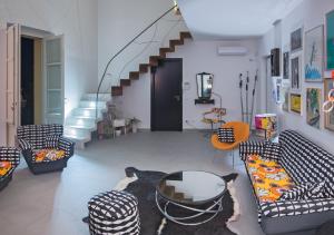 a living room with two couches and a staircase at Terrazze Ginevra in Palermo