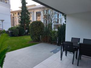 a patio with two chairs and a table in front of a building at Ferienwohnung Evelina in Bad Neuenahr-Ahrweiler