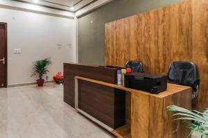an office cubicle with a desk with a computer on it at Hotel O Utrishree in Khandagiri