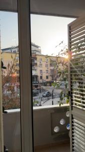 a window with a view of a parking lot at Agora ApartHotel in Tirana