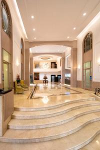 a lobby with a large staircase in a building at Hotel Dann Carlton Medellín in Medellín +69 photos
