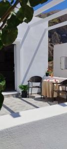 a table and two chairs on a patio at LEIVADAROS apartments in Perissa