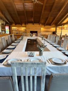 a long dining room with a long table and chairs at Hotel las Caballerizas in Valle de Bravo +17 photos