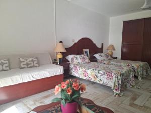 a hotel room with two beds and a couch at Just in paradise in Baie Nettle +159 photos