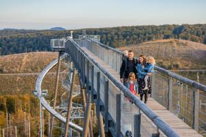 a family standing on a bridge on a roller coaster at FeWo Heaven in Winterberg
