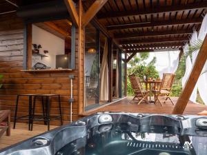 a bath tub in the middle of a house at Bungalow en duplex avec Jacuzzi in Sainte-Rose
