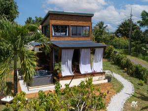 a house on a hill with a tree at Bungalow en duplex avec Jacuzzi in Sainte-Rose +4 photos