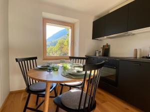 a kitchen with a table and chairs and a window at Casa Castanea in Breiten +17 photos