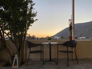 a table and two chairs on a patio with a view at LEIVADAROS apartments in Perissa