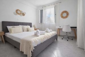 a bedroom with a bed with two stuffed animals on it at LD Home in Lixouri