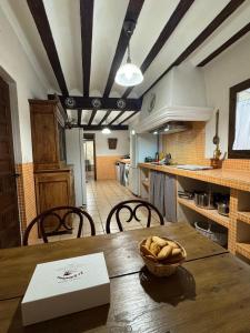 a kitchen with a table with a bowl of bread on it at La Casa de Dori in Beteta +53 photos