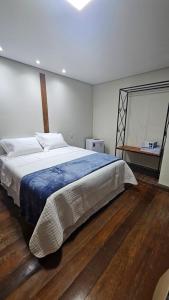 a bedroom with a large bed in a room at Casa Violeta in Ouro Preto +5 photos