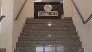 a set of stairs in a building with a sign at Hotel am Hexenturm in Jülich