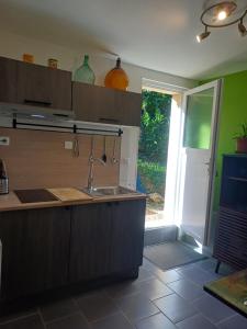 a kitchen with a sink and a counter top at La Marceline Gîte avec piscine près de Lascaux IV in Aubas