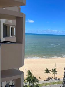 a view of the beach from the balcony of a building at Flat Costa Mar in Recife