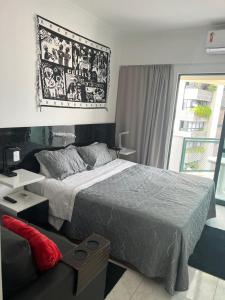 a bedroom with a bed and a large picture on the wall at Flat Costa Mar in Recife