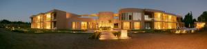 a large building with lights in front of it at Howard Johnson Alcántara Boutique Hotel Chacras de Coria, Mendoza in Chacras de Coria