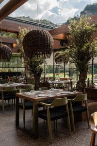 a restaurant with tables and chairs in a room at Selemnos Boutique in Patra