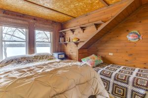 a bedroom with a bed in a log cabin at Rustic Poland Vacation Rental w/ Waterfront Deck! in Poland