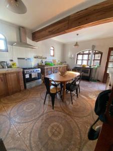a kitchen with a table and chairs in a room at Casona san isidro in Vicuña
