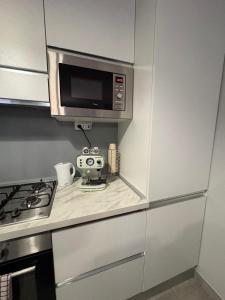 a kitchen with a microwave and a coffee maker on a counter at Ladybug in Canale