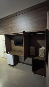 a large wooden entertainment center in a room at Hotel Luz in Fronteira +27 photos