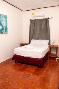 a bed in a room with a white bedvisor at Casa Verde in Granada
