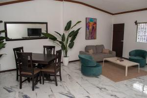 a living room with a table and a couch at Casa Verde in Granada
