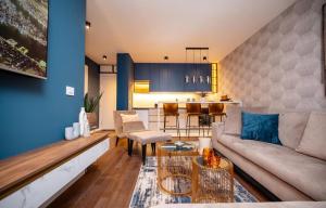 a living room with a couch and a table at Impresia apartments in Kragujevac