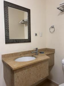 a bathroom with a sink and a mirror at Hotel Ruiz Milán in Veracruz +21 photos