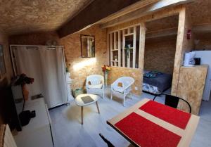 a small room with a table and chairs in a room at Chez Marie in Le Pallet