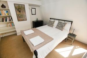 a bedroom with a bed and a book shelf at Marine Gardens - Central - by Brighton Holiday Lets in Brighton & Hove