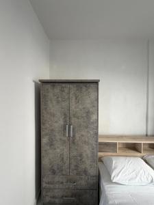 a bedroom with a wooden cabinet next to a bed at Mirage Luxury Living in Nea Potidaea +16 photos