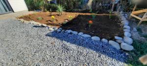 a garden with rocks and a small garden with a plot of dirt at Cabaña Guzman in Villarrica